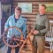 Dee Schaefer pictured with Erling Skjonsbyhagen and the Rokk – a spinning wheel that belonged to Dee’s ancestors. (Submitted photo)